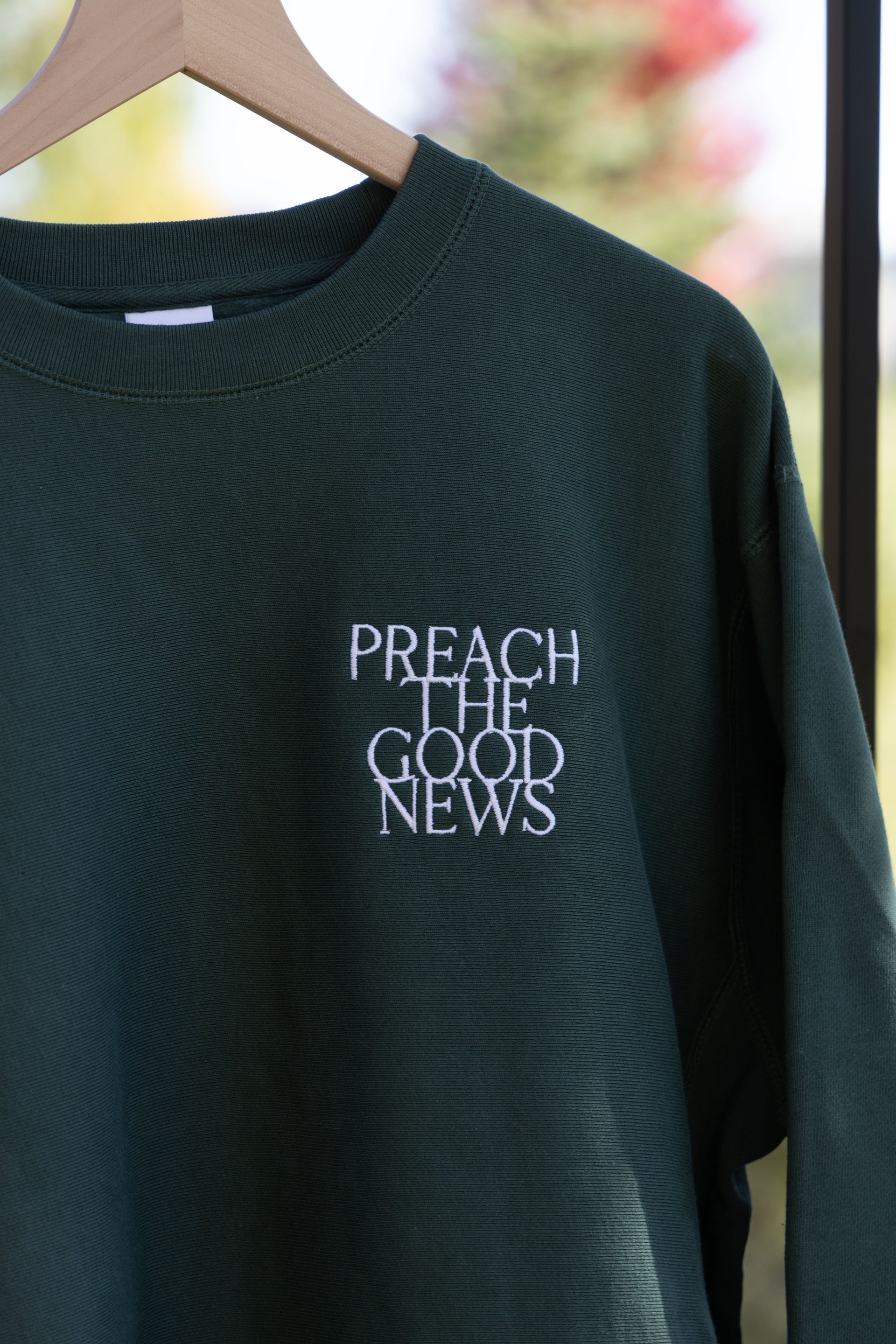 PREACH THE GOOD NEWS PREMIUM CREWNECK green front embroidery detail